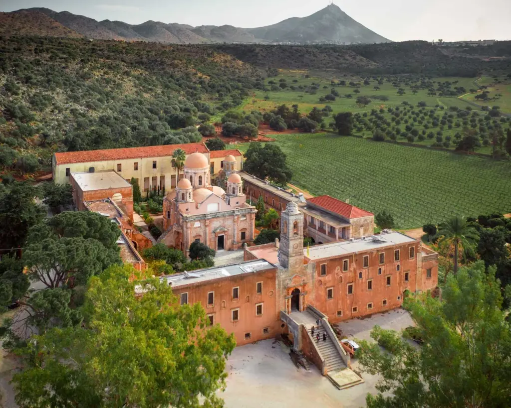 The complete complex of Agia Triada Monastery surrounded by its vineyards and olive groves