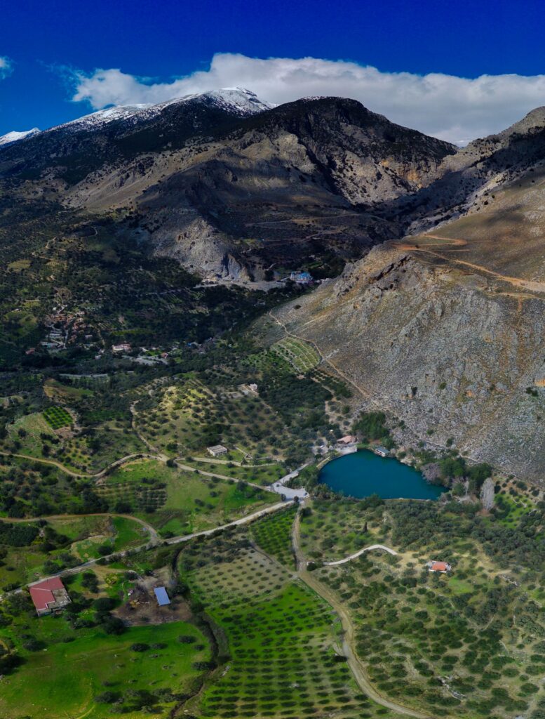 Zaros Village & Lake: Drone view of Zaros lake under the great mountain of Psiloritis and the surrounding field area.